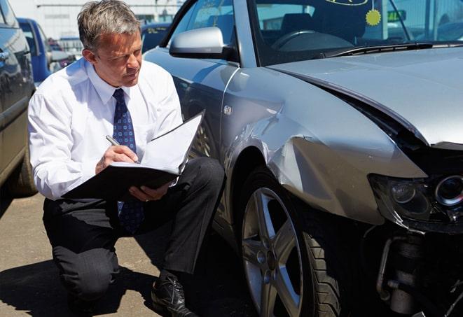 car accident scene with police and insurance adjusters